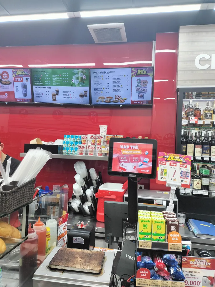 Circle K counter in Vietnam with digital menu boards above the drinks station