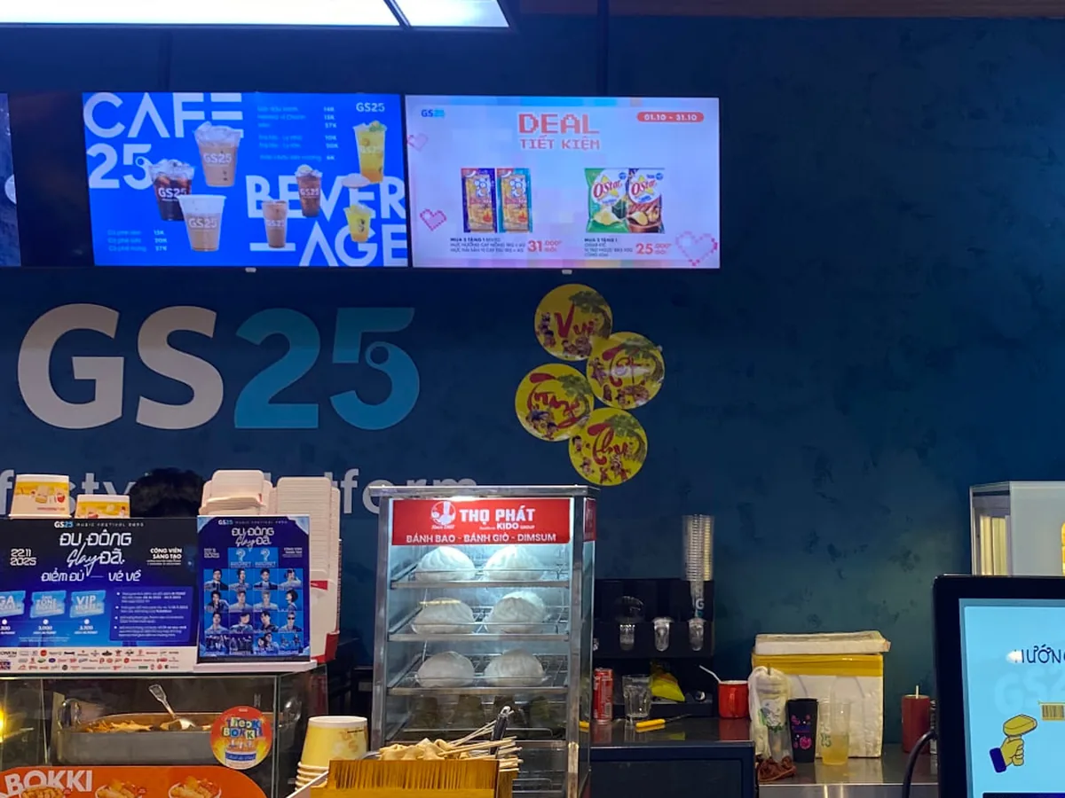 GS25 convenience store counter with a digital menu board showing Cafe25 beverages