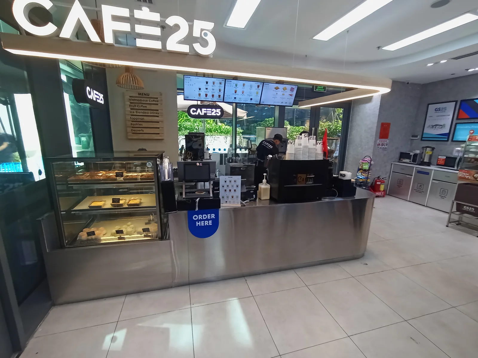 GS25 store interior in Vietnam with digital menu screens above the Cafe25 counter